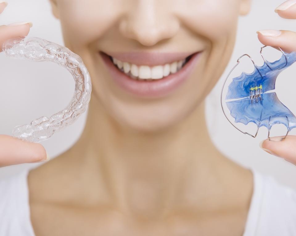 Lady holding two different types of retainers